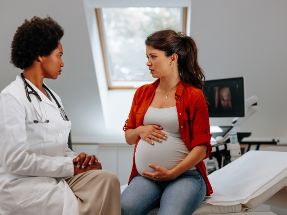 pregnant lady talking to a doctor