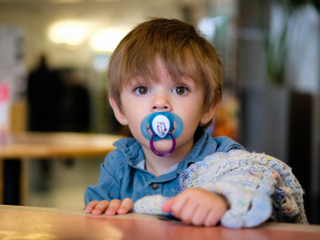 Toddler boy with dummy in his mouth