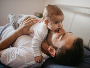 Baby lying on their dad's tummy