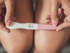 Woman holding pregnancy test