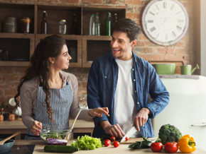 woman and man in the kitchen cutting up healthy food