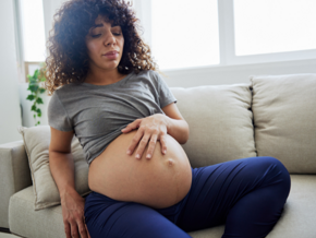 Pregnant lady holding stomach in pain