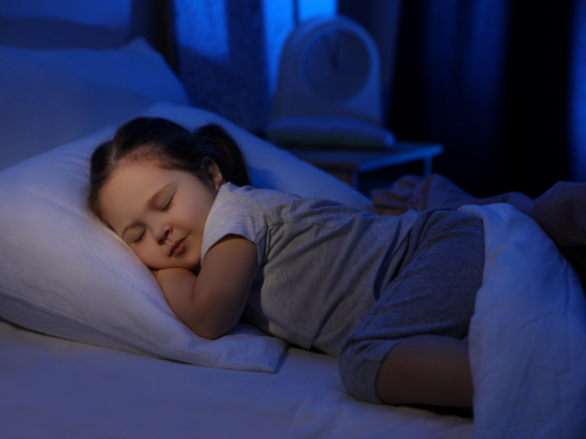 Toddler girl asleep in bed