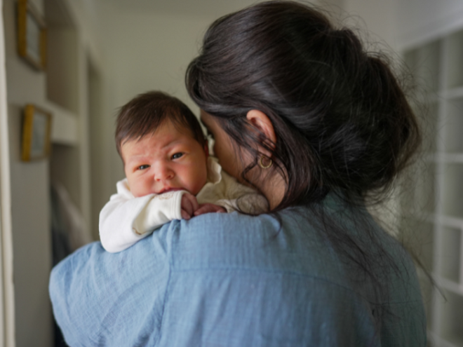 Mother holding upset baby