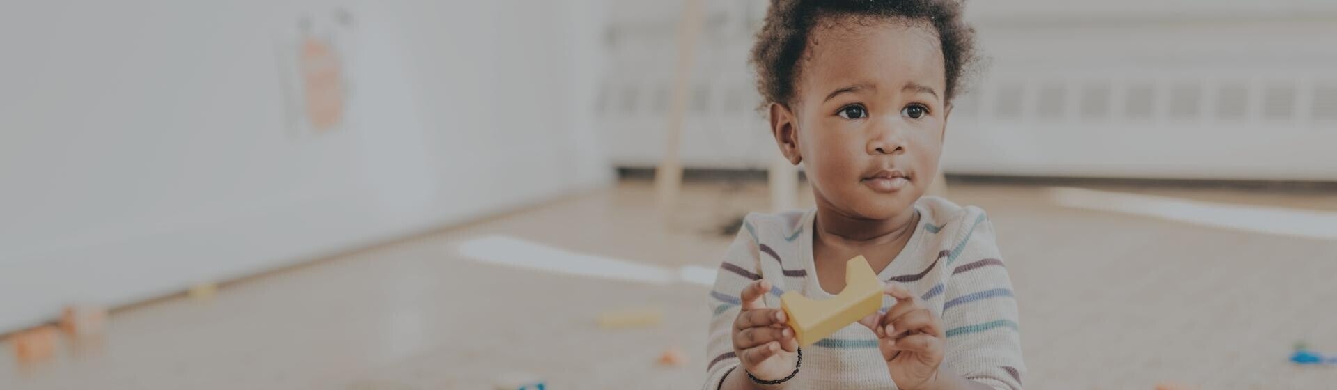 Toddler playing with building blocks