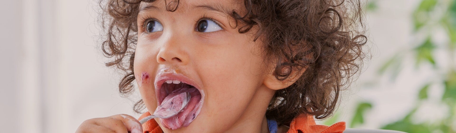 toddler eating yoghurt