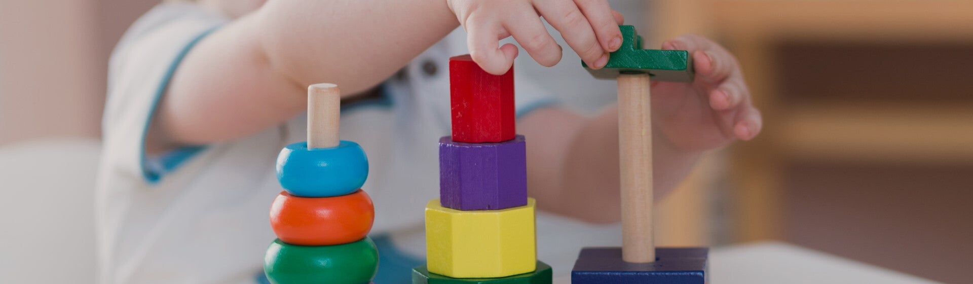 toddler playing with wooden blocks