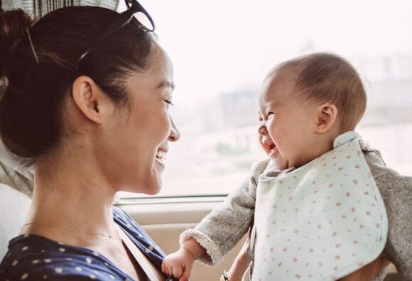 mum and baby laughing at each other