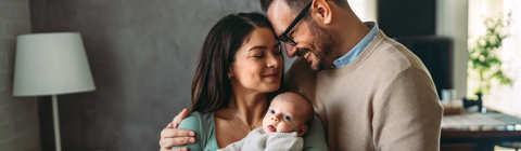 mother and father holding their baby