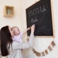 mum writing menu on blackboard